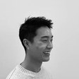 Young Kim, in profile, laughing.